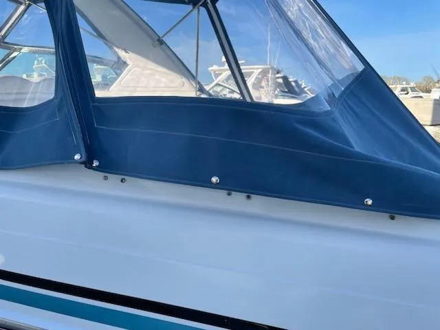 Slide: The Image of 2005 Formula 330 Sun Sport boat with blue canvas cover. - 19