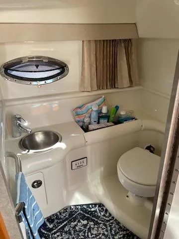 Slide: The Image of 2005 Formula 330 Sun Sport boat bathroom with sink, toilet, and storage. - 26