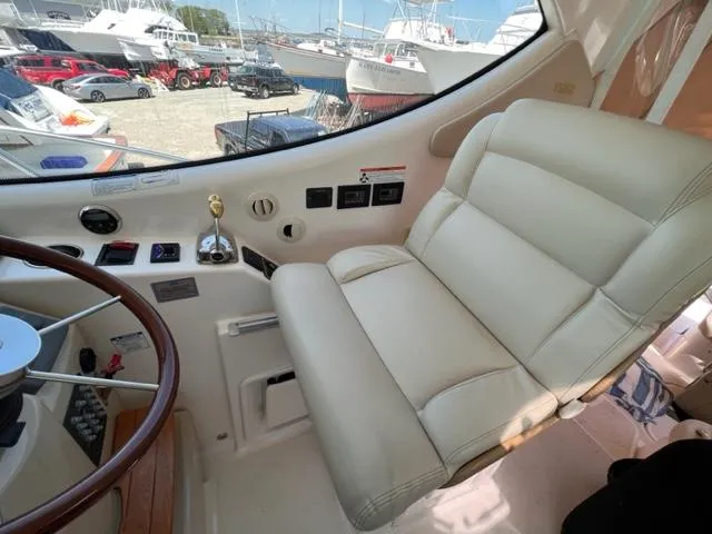 Slide: The Image of 2008 Tiara Yachts 3900 Sovran helm seat and dashboard with marina view. - 13