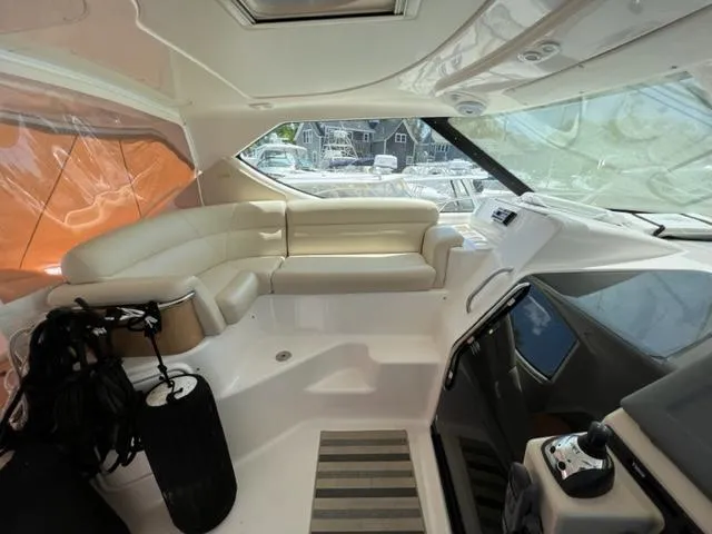 Slide: The Image of 2008 Tiara Yachts 3900 Sovran interior with white leather seating and helm station. - 16