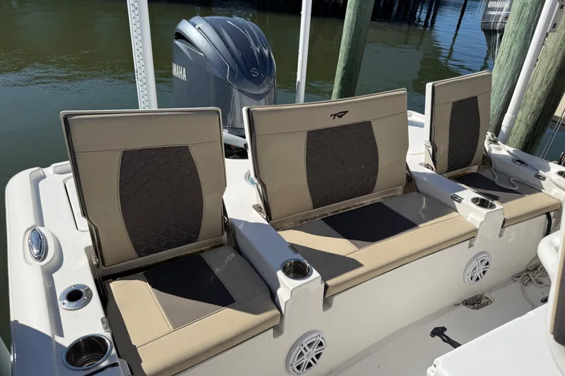 Slide: The Image of 2022 Tidewater 2500 Carolina Bay boat seats with Yamaha engine in marina setting. - 11