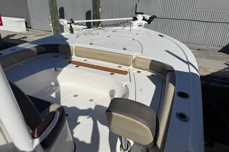 Slide: The Image of 2022 Tidewater 2500 Carolina Bay boat interior with seating and fishing rod holders. - 12