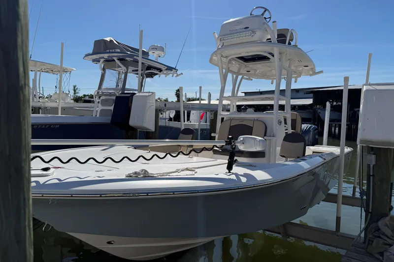 Slide: The Image of 2022 Tidewater 2500 Carolina Bay boat docked at marina under clear blue sky. - 3