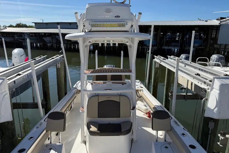 Slide: The Image of 2022 Tidewater 2500 Carolina Bay boat docked at marina, showcasing seating and helm. - 6