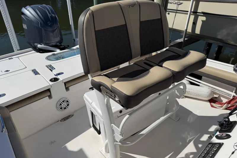 Slide: The Image of 2022 Tidewater 2500 Carolina Bay boat interior with dual seats and Yamaha engine. - 7
