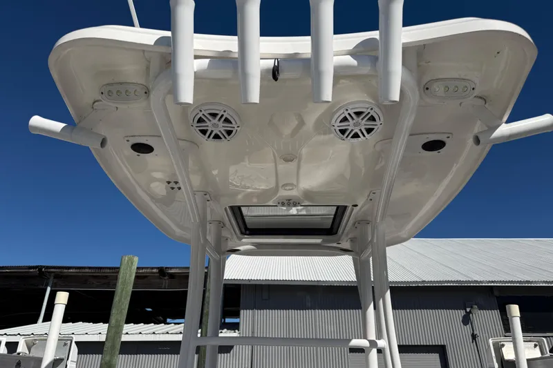 Slide: The Image of 2022 Tidewater 2500 Carolina Bay boat's T-top with speakers and rod holders. - 9