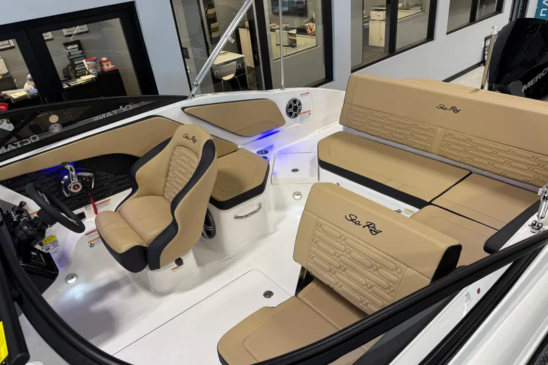 Slide: The Image of 2026 Sea Ray SPX 210 Outboard boat interior with tan seating and modern dashboard. - 11