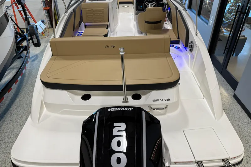Slide: The Image of 2026 Sea Ray SPX 210 Outboard boat with Mercury 200 engine, beige seating, and modern interior. - 14
