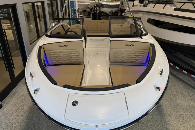 Slide: The Image of 2026 Sea Ray SPX 210 Outboard boat interior with tan seating and modern design. - 19