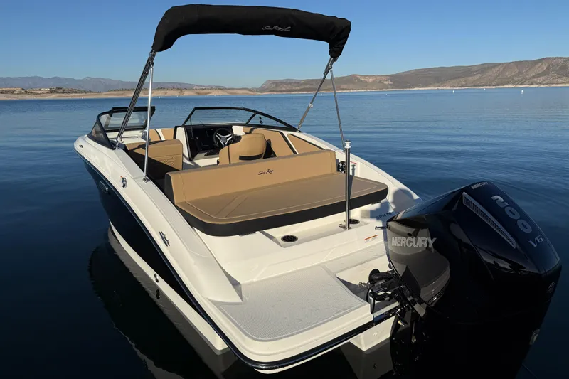Slide: The Image of 2026 Sea Ray SPX 210 Outboard boat on calm water with scenic mountain backdrop. - 2