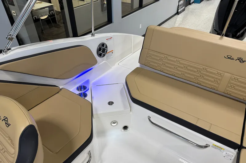 Slide: The Image of 2026 Sea Ray SPX 210 Outboard interior with tan seating and blue LED lighting. - 22