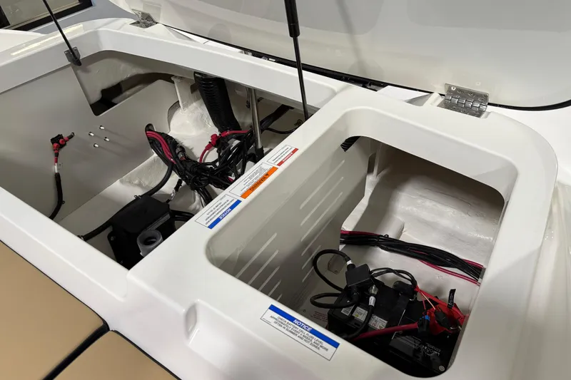 Slide: The Image of 2026 Sea Ray SPX 210 Outboard engine compartment with wiring and battery setup. - 25