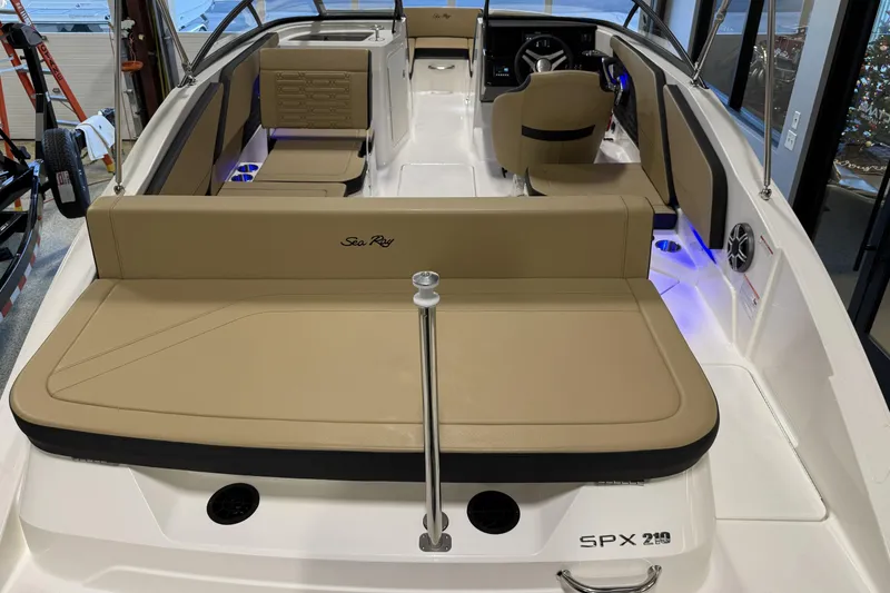Slide: The Image of 2026 Sea Ray SPX 210 Outboard boat interior with tan seating and modern design. - 26