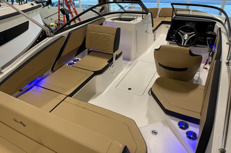 Slide: The Image of 2026 Sea Ray SPX 210 Outboard interior with tan seating and modern dashboard. - 27