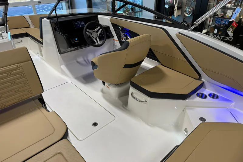Slide: The Image of 2026 Sea Ray SPX 210 Outboard boat interior with tan seating and modern dashboard. - 32