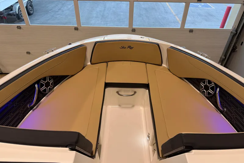 Slide: The Image of 2026 Sea Ray SPX 210 Outboard boat interior with tan seating and speakers. - 35