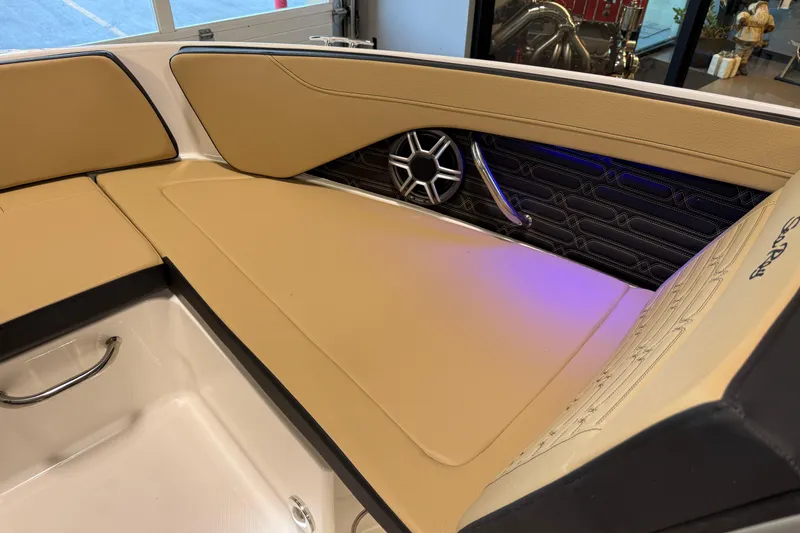 Slide: The Image of 2026 Sea Ray SPX 210 Outboard interior with tan seating and stylish speaker design. - 37