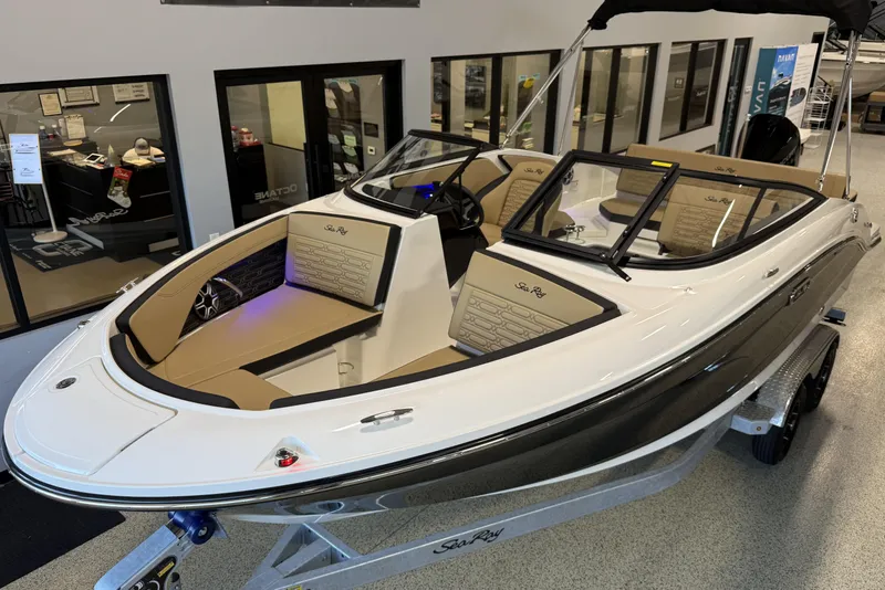 Slide: The Image of 2026 Sea Ray SPX 210 Outboard boat displayed indoors on a trailer. - 9