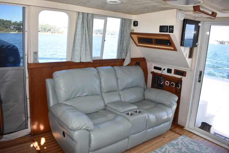 Slide: The Image of Interior of 2001 Mainship 390 yacht with leather sofa and ocean view. - 14