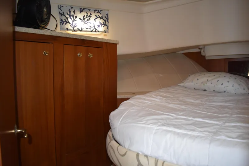 Slide: The Image of Cozy cabin interior of 2001 Mainship 390 with bed and wooden cabinetry. - 26