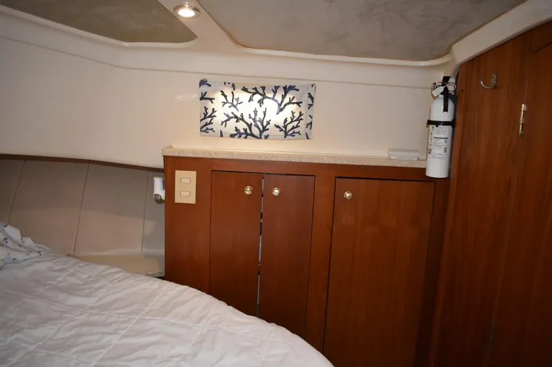 Slide: The Image of Cozy cabin interior of 2001 Mainship 390 with wooden cabinets and nautical decor. - 29