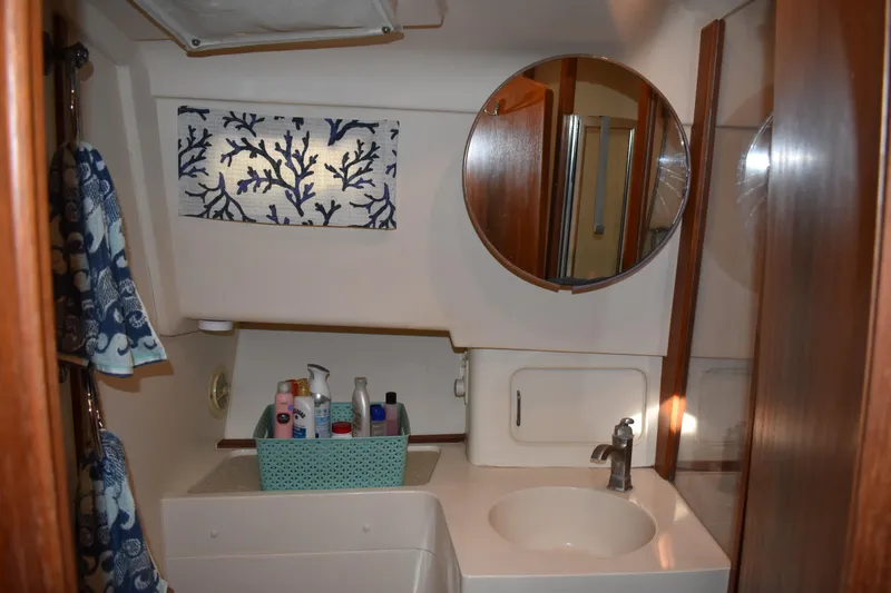 Slide: The Image of Bathroom interior of 2001 Mainship 390 yacht with mirror and toiletries. - 33