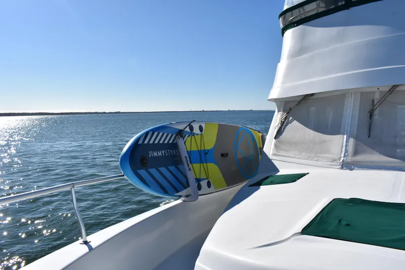 Slide: The Image of 2001 Mainship 390 yacht with paddleboard on deck, cruising on a sunny day. - 41
