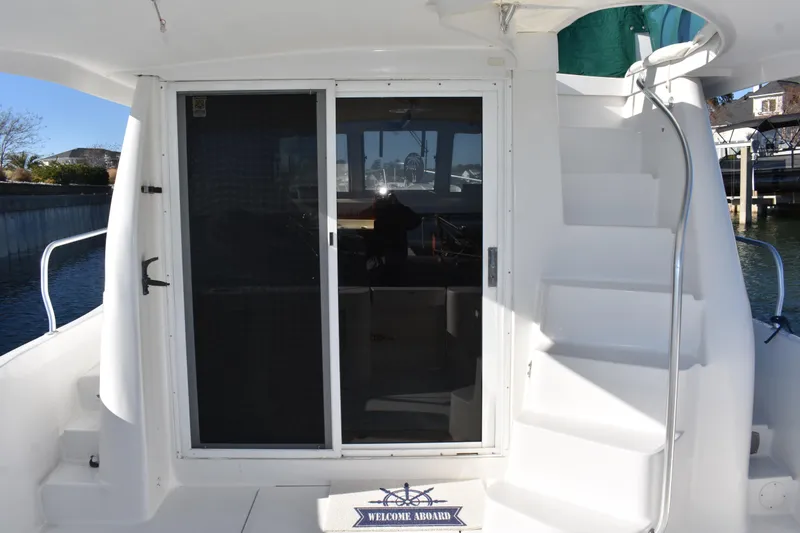 Slide: The Image of 2001 Mainship 390 yacht with sliding doors and exterior staircase. - 46