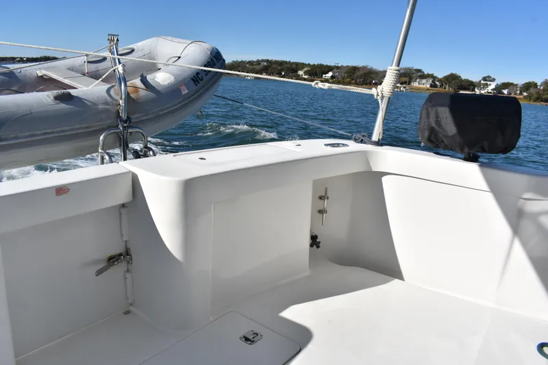 Slide: The Image of 2001 Mainship 390 boat deck with inflatable dinghy on calm water. - 54