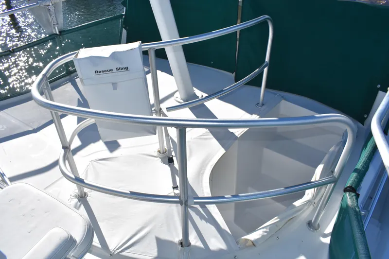 Slide: The Image of 2001 Mainship 390 boat deck with rescue sling and safety railings. - 55
