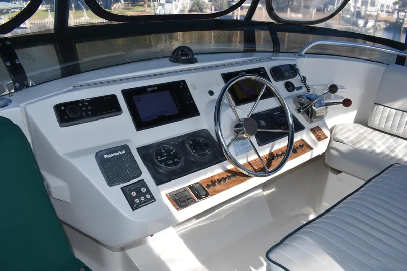 Slide: The Image of Helm of 2001 Mainship 390 with navigation instruments and steering wheel. - 63
