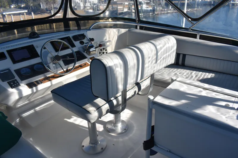 Slide: The Image of 2001 Mainship 390 yacht helm with steering wheel and cushioned seating. - 66