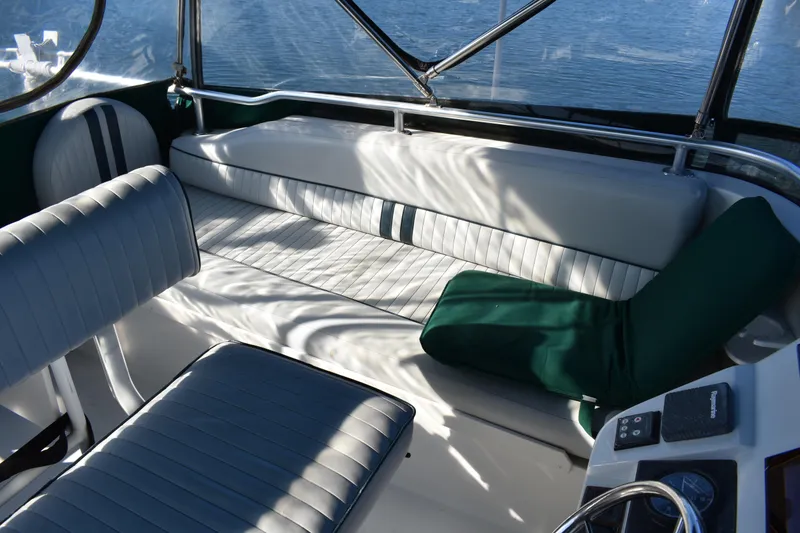 Slide: The Image of Interior seating of 2001 Mainship 390 boat with cushioned seats and green accents. - 69