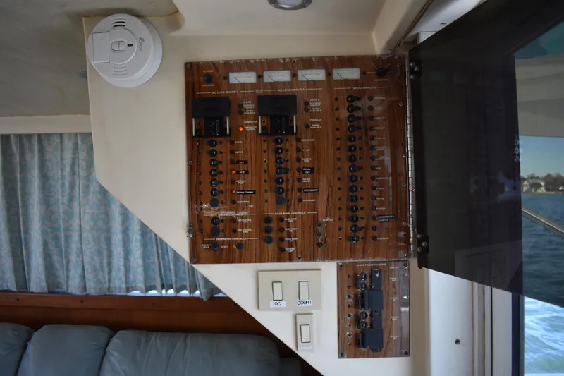 Slide: The Image of Electrical panel inside a 2001 Mainship 390 boat, featuring switches and controls. - 71