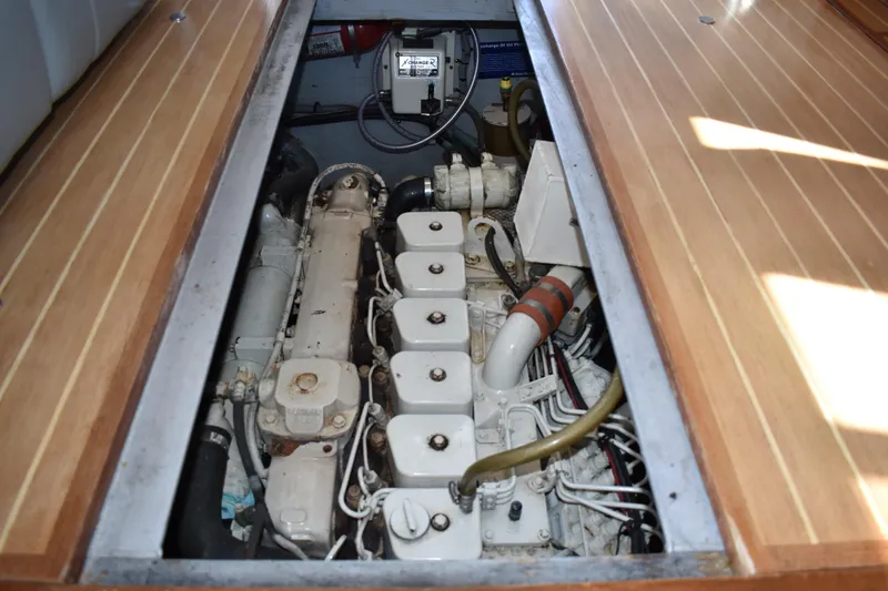 Slide: The Image of Engine compartment of a 2001 Mainship 390 boat, showcasing detailed mechanical components. - 74