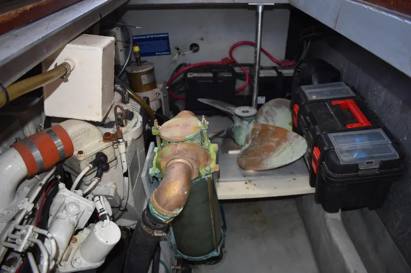 Slide: The Image of Engine room of a 2001 Mainship 390 boat with propeller and toolboxes. - 76