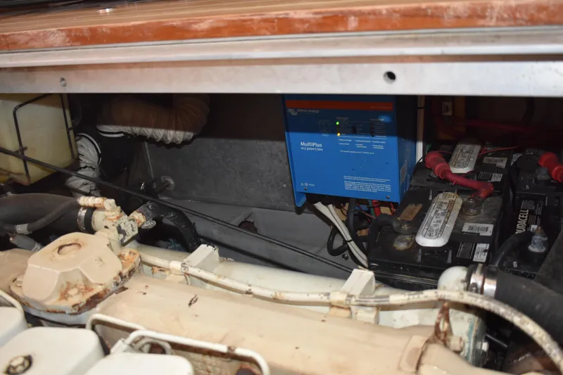 Slide: The Image of Engine compartment of a 2001 Mainship 390 with batteries and electrical components. - 77