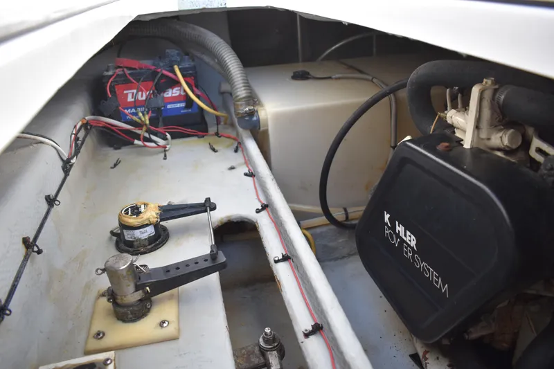 Slide: The Image of Engine compartment of 2001 Mainship 390 with Kohler power system and battery. - 80