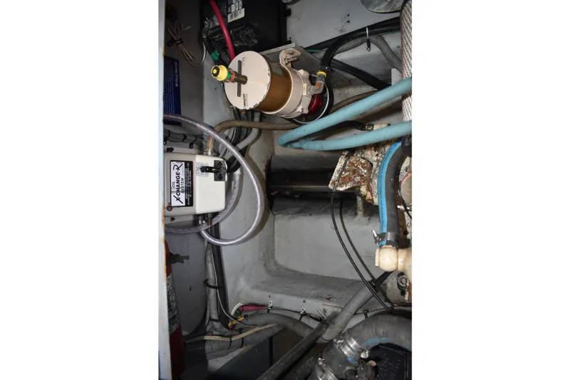 Slide: The Image of Engine compartment of a 2001 Mainship 390 boat, showing mechanical components and wiring. - 81