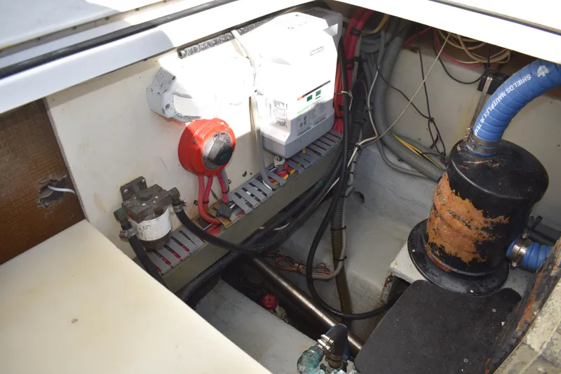 Slide: The Image of Engine compartment of a 2001 Mainship 390 boat, showing electrical components and wiring. - 82