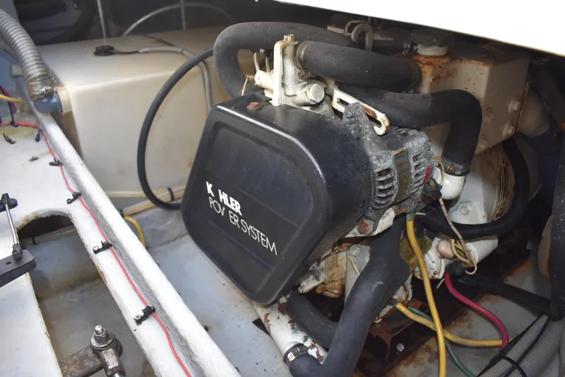 Slide: The Image of Engine compartment of a 2001 Mainship 390 boat with Kohler power system. - 84