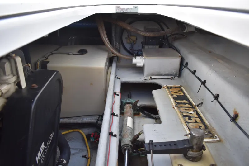 Slide: The Image of Engine compartment of a 2001 Mainship 390 boat, showing mechanical components and wiring. - 85