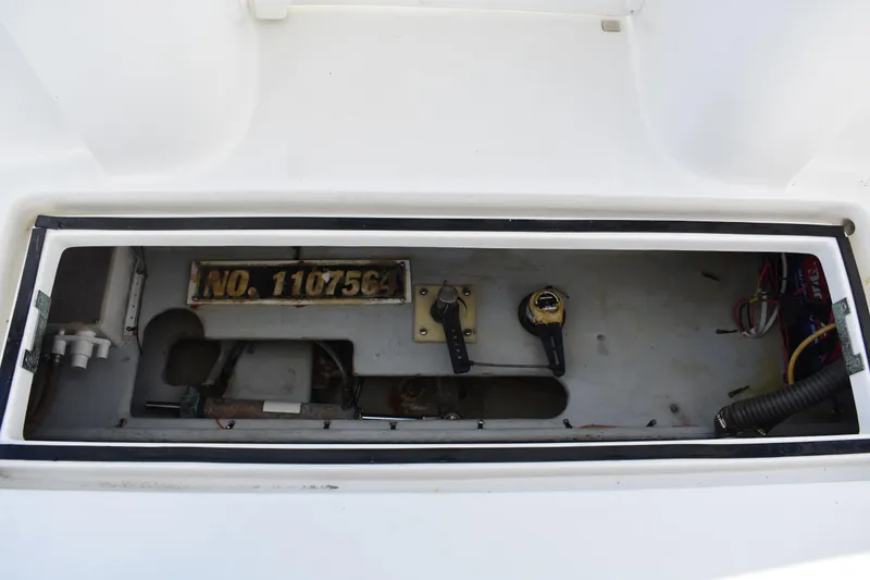 Slide: The Image of 2001 Mainship 390 boat compartment with wiring and control mechanisms visible. - 86