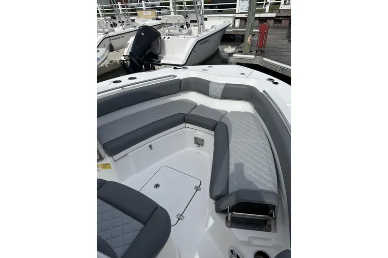 Slide: The Image of 2024 NauticStar 222L Offshore boat interior with gray seating and storage compartments. - 6