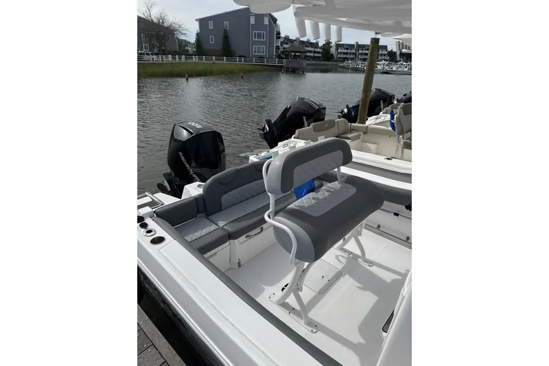 Slide: The Image of 2024 NauticStar 222L Offshore boat interior with seating and outboard motors. - 7