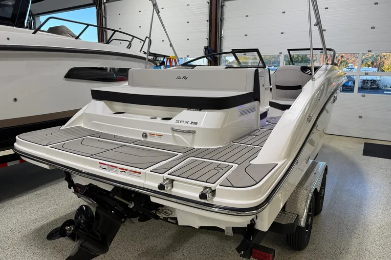 Slide: The Image of 2026 Sea Ray SPX 210 boat in showroom, rear view on trailer. - 12