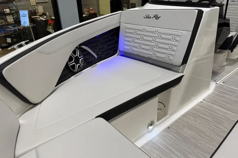 Slide: The Image of 2026 Sea Ray SPX 210 boat interior with stylish seating and ambient lighting. - 18