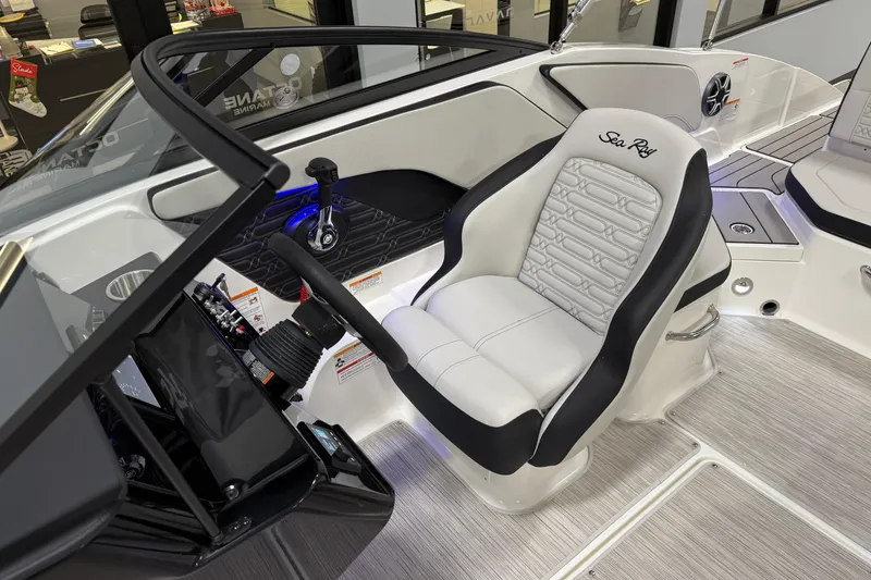 Slide: The Image of 2026 Sea Ray SPX 210 boat interior with steering wheel and captain's seat. - 22