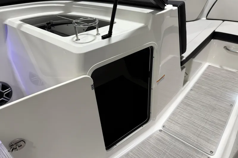Slide: The Image of 2026 Sea Ray SPX 210 boat interior with storage compartment and seating area. - 34