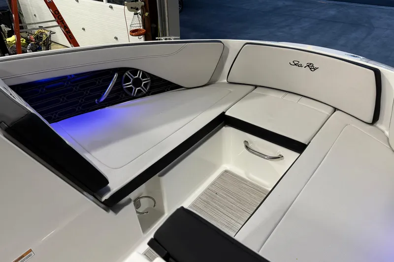 Slide: The Image of Interior of 2026 Sea Ray SPX 210 boat with white seating and blue accent lighting. - 39